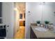 Bright bathroom features a granite countertop and adjacent doorway to kitchen at 2333 E Southern Ave # 2033, Tempe, AZ 85282