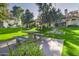 Community common area with lush lawn, mature shade trees, and picnic benches on concrete pads at 2333 E Southern Ave # 2033, Tempe, AZ 85282