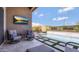 Backyard with sparkling pool, lush green grass, and an outdoor television at 23448 N 76Th Pl, Scottsdale, AZ 85255