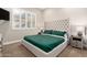 Cozy bedroom featuring a plush, tufted headboard, complemented by soft lighting and a serene atmosphere at 23448 N 76Th Pl, Scottsdale, AZ 85255