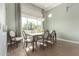 Dining room featuring modern light fixture and large window with natural light at 23448 N 76Th Pl, Scottsdale, AZ 85255