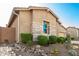 Charming home exterior with stone accents, desert landscaping, and mature plants at 23448 N 76Th Pl, Scottsdale, AZ 85255