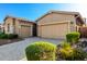 The exterior showcases a desert-style landscape with a paver driveway and muted exterior paint at 23448 N 76Th Pl, Scottsdale, AZ 85255