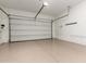 Clean, spacious garage with epoxy flooring, offering ample room for parking and storage, plus overhead lighting at 23448 N 76Th Pl, Scottsdale, AZ 85255