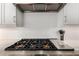 Close-up view of the professional-grade gas range and stainless steel vent hood at 23448 N 76Th Pl, Scottsdale, AZ 85255