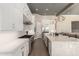 Gourmet kitchen with white cabinets, stainless steel appliances, and expansive countertops at 23448 N 76Th Pl, Scottsdale, AZ 85255