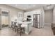 Well-lit kitchen features stainless steel appliances, a breakfast bar, and stylish countertops at 23448 N 76Th Pl, Scottsdale, AZ 85255