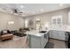 Open-concept kitchen flows to living area with stainless steel appliances and a breakfast bar at 23448 N 76Th Pl, Scottsdale, AZ 85255