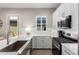 Modern kitchen features white cabinets, stainless steel appliances, and a stylish breakfast bar at 23448 N 76Th Pl, Scottsdale, AZ 85255
