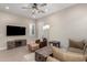 Comfortable living room with a large TV, stylish furniture, and ample space for relaxation at 23448 N 76Th Pl, Scottsdale, AZ 85255