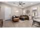 Cozy living room features a ceiling fan, stylish furniture, and wood-look tile flooring at 23448 N 76Th Pl, Scottsdale, AZ 85255