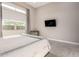 Cozy bedroom featuring a comfortable bed, large window, and modern decor at 23448 N 76Th Pl, Scottsdale, AZ 85255