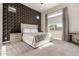 Serene bedroom with a geometric accent wall, plush carpet, and natural light at 23448 N 76Th Pl, Scottsdale, AZ 85255