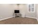 Minimalist office space with a functional desk and a window with plantation shutters, offering a clean, bright workspace at 23448 N 76Th Pl, Scottsdale, AZ 85255