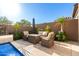 Elegant outdoor living space with travertine patio and comfortable seating area at 23448 N 76Th Pl, Scottsdale, AZ 85255