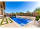 Sparkling pool features a baja shelf and desert mountain accents at 23448 N 76Th Pl, Scottsdale, AZ 85255