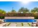 Stunning pool with baja shelf, desert mountain accents, and travertine tile at 23448 N 76Th Pl, Scottsdale, AZ 85255
