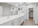 Bright bathroom featuring a double vanity, sleek cabinets, and modern fixtures at 25727 N 161St Ave, Surprise, AZ 85387