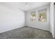 Neutral bedroom with two windows, gray carpet, and a ceiling fan for added comfort at 25727 N 161St Ave, Surprise, AZ 85387