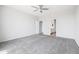 Bright bedroom with a ceiling fan, carpet floors, and an en-suite bathroom at 25727 N 161St Ave, Surprise, AZ 85387