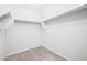 Walk-in closet with built-in shelving and laminate flooring at 25727 N 161St Ave, Surprise, AZ 85387