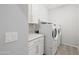 Well-lit laundry room featuring white cabinetry, countertop, and modern appliances at 25727 N 161St Ave, Surprise, AZ 85387