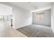 Open-concept living space with large windows, fan, and gray carpet flooring at 25727 N 161St Ave, Surprise, AZ 85387