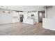 Open concept kitchen and living room with white cabinetry, large island, and stainless steel appliances at 25727 N 161St Ave, Surprise, AZ 85387