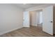 Bright bedroom features wood-look floors, neutral walls, white trim, and a white door at 2647 N Miller Rd # 6, Scottsdale, AZ 85257