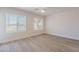 Bedroom features wood-look floors, neutral walls, white trim, blinds, and a ceiling fan at 2647 N Miller Rd # 6, Scottsdale, AZ 85257