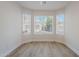 Bright bedroom features wood-look floors, neutral walls, white trim, and three windows at 2647 N Miller Rd # 6, Scottsdale, AZ 85257