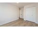 Bedroom boasts neutral walls, wood-look floors, white trim, and a large closet at 2647 N Miller Rd # 6, Scottsdale, AZ 85257