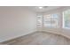 Bright bedroom features wood-look floors, neutral walls, white trim, and a ceiling fan at 2647 N Miller Rd # 6, Scottsdale, AZ 85257