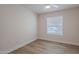 Bedroom with luxury vinyl flooring and a large window with blinds at 2647 N Miller Rd # 6, Scottsdale, AZ 85257