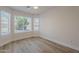 Bright bedroom features wood-look floors, neutral walls, white trim, and a ceiling fan at 2647 N Miller Rd # 6, Scottsdale, AZ 85257