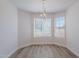 Dining room featuring luxury vinyl flooring, lots of natural light, and decorative light fixture at 2647 N Miller Rd # 6, Scottsdale, AZ 85257