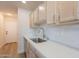 Updated kitchen featuring a stainless steel sink, stylish countertops, and wood-style flooring at 2647 N Miller Rd # 6, Scottsdale, AZ 85257