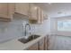 Well-lit kitchen boasting stainless steel sink, new countertops, and wood-style flooring at 2647 N Miller Rd # 6, Scottsdale, AZ 85257