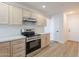 Updated kitchen with stainless steel appliances, bright white backsplash, and light wood cabinets at 2647 N Miller Rd # 6, Scottsdale, AZ 85257