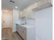 Bright kitchen features light wood cabinetry, white subway tile backsplash, and stainless steel sink at 2647 N Miller Rd # 6, Scottsdale, AZ 85257