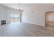 Bright living room featuring luxury vinyl flooring, a fireplace, and sliding glass doors to the patio at 2647 N Miller Rd # 6, Scottsdale, AZ 85257