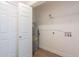 Utility closet with water heater, laminate flooring, and storage shelf ensures functionality at 2647 N Miller Rd # 6, Scottsdale, AZ 85257