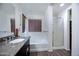 Bright bathroom features a soaking tub, glass shower, and granite countertops at 2715 N 73Rd Dr, Phoenix, AZ 85035