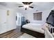 Bedroom featuring a ceiling fan, wood-look floors, and a modern crib at 2715 N 73Rd Dr, Phoenix, AZ 85035