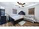 Spacious bedroom with a ceiling fan, wood-look floors, and a modern crib at 2715 N 73Rd Dr, Phoenix, AZ 85035
