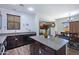 Kitchen showcasing an island, wood cabinets, stainless dishwasher, and eat-in dining area at 2715 N 73Rd Dr, Phoenix, AZ 85035