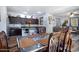 Open kitchen and dining area with dark wood cabinetry and granite countertops at 2715 N 73Rd Dr, Phoenix, AZ 85035