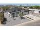 An aerial view shows this well-maintained home with a xeriscaped yard, modern design, and mountain views at 2790 W Cholla St, Apache Junction, AZ 85120