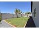 This backyard features a grassy area and a block fence at 2790 W Cholla St, Apache Junction, AZ 85120