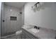 Bathroom featuring a stylish vanity, granite counters, black hardware, and a tiled shower with glass doors at 2790 W Cholla St, Apache Junction, AZ 85120